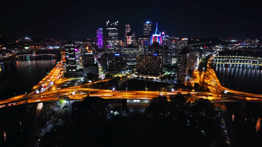 Retreating Establishing Aerial shot of Downtown Pittsburgh, Pennsylvania. Skyscrapers of downtown during night. amazing Aerial shot.