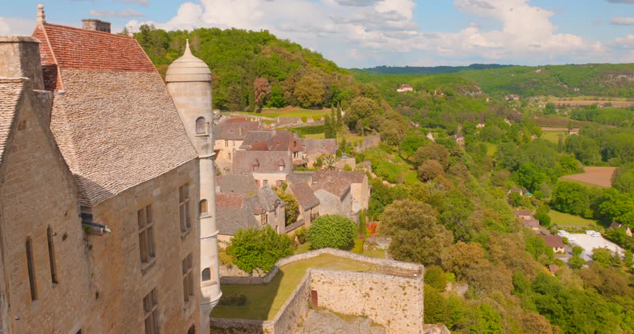 View of serene landscape from the Beynac Castle of Dordogne valley in France. Forested hills.