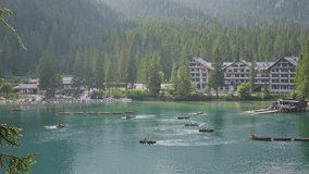 Tourists enjoy rowing boat activity on Dolomites Alpine Lake Braies - Powered by Shutterstock - Get 15% off with code: PIKWIZARD15