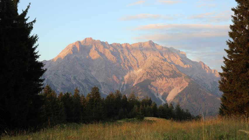 Hochkönig mountain ridge in Austria. Alps mountains beautiful landscape. Austrian Alps in Salzburg region Salzburger almenweg hiking trail scenic video timelapse of clouds moving above Hochkonig ridge