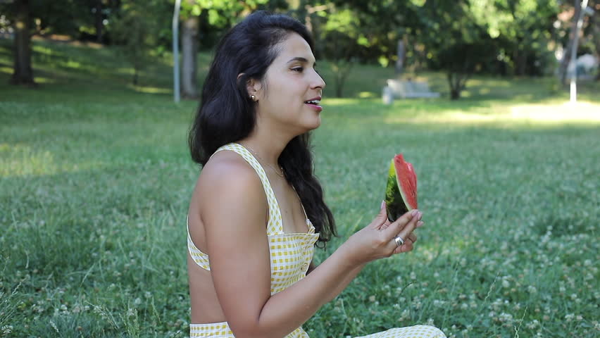 Woman eating a watermelon slice 