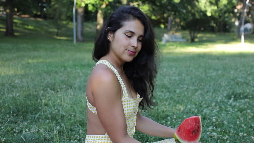 Woman eating a watermelon slice 