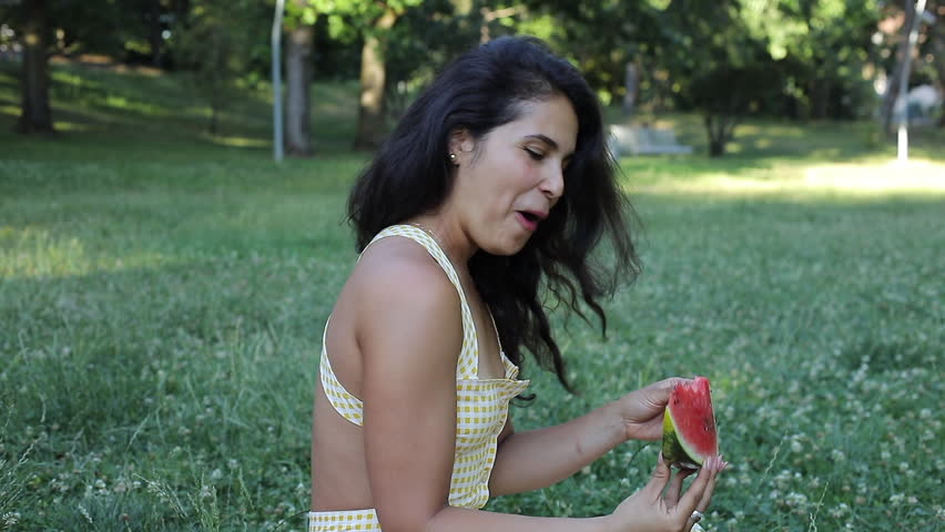 Woman eating a watermelon slice 