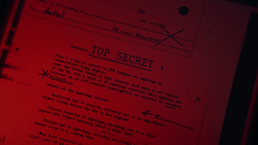 Top secret classified file or report of government agency is passed by scanner or being copied in machine with scan line in dark red room. Conspiracy or fraud. Exposing secrets and shady evidence data