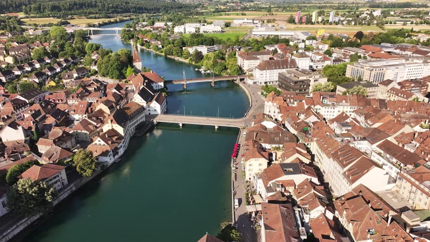 Olten city in Switzerland with Aare river, beautiful aerial drone view, historic old town and bridges on sunny summer day.