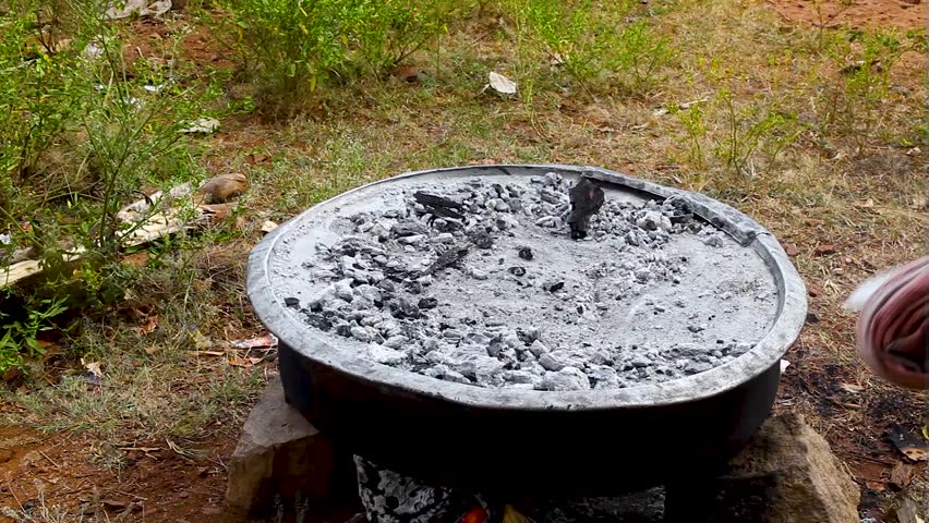 cooking pizza outdoors, a huge pizza that is topped with cheese