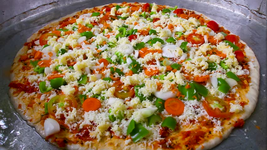 huge pizza that is topped with cheese