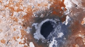 Aerial view of a geothermal area in Iceland, likely Namafjall, with vibrant orange and white mineral deposits and steam wafting from fumaroles. - Powered by Shutterstock - Get 15% off with code: PIKWIZARD15