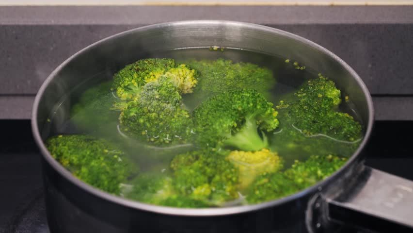 Green broccoli florets simmer. Healthy simple delicious food.