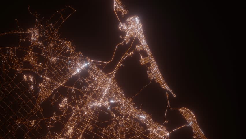 Atlantic City (New Jersey, USA) aerial view at night. Top view on modern city with street lights. Camera is zooming out, rotating clockwise. Vertical video. The north is on the left side