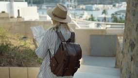 Traveler descending city stairs, checking map, wearing backpack, seeking destination during summer exploration of urban landscape.Europe travel. Lifestyle, vacation, tourism,nature, active life - Powered by Shutterstock - Get 15% off with code: PIKWIZARD15