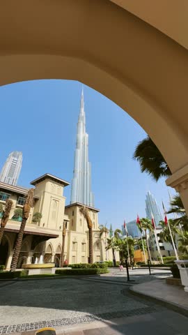 Panoramic Dubai downtown view architecure and tallest building Burj Khalifa at backgrund framed by elegant arches, vertical view, no logos