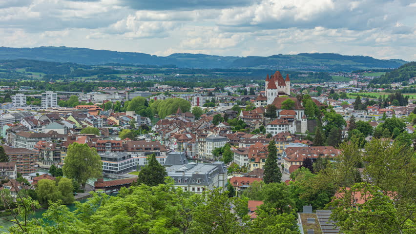 Time lapse, old European town with castle and river. Thun Castle, Aare river, Thun, canton of Bern, Switzerland.