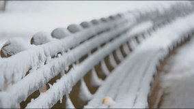 Footage features a wooden park bench covered in snow during snowfall in Central Park, NYC, creating a peaceful, winter scene in the city. - Powered by Shutterstock - Get 15% off with code: PIKWIZARD15