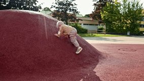 Boy 2 years old running and playing outside. Toddler climbing a hill on the playground. Child conquering heights. Child learning to climb a mountain. - Powered by Shutterstock - Get 15% off with code: PIKWIZARD15