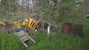 Discarded items and rusted barrels in a rural overgrown junkyard - Powered by Shutterstock - Get 15% off with code: PIKWIZARD15