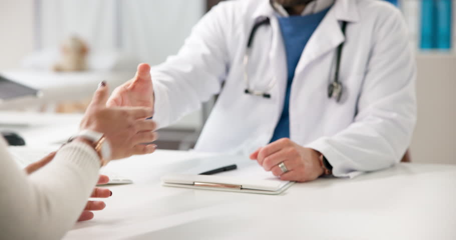 Doctor, people and meeting with shaking hands in office for consultation, welcome and healthcare services. Handshake, patient and greeting for good news, medical diagnosis and document discussion