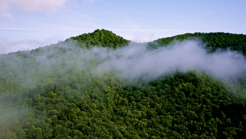 Cinematic drone shot of mist drifting over the Smoky Mountains in the United States.