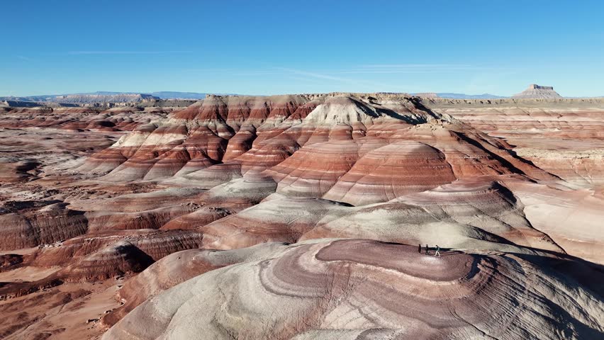 Drone Shot of People on Top of Bentonite Hill in Picturesque Landscape of Utah USA
