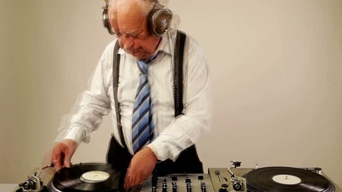 a very funky elderly grandpa dj mixing records
