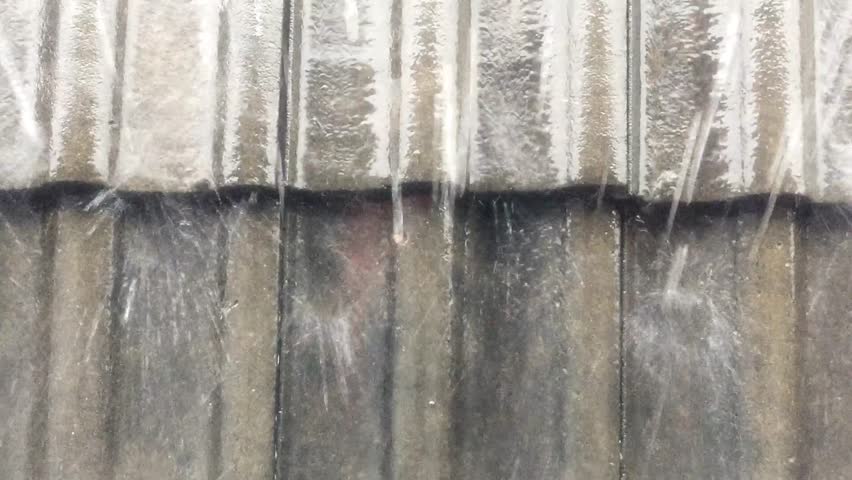 Heavy rain on the concrete roof.