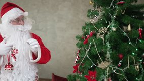 Santa Claus is preparing a gift and decorating Christmas tree for Christmas eve. Holiday, celebration. - Powered by Shutterstock - Get 15% off with code: PIKWIZARD15