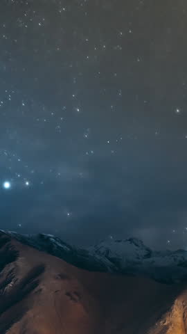 Stepantsminda, Georgia. Georgian Landscape In Winter Season. Hyperlapse Night Bright Starry Sky With Glowing Stars Above Peak Of Mount Kazbek Covered With Snow.