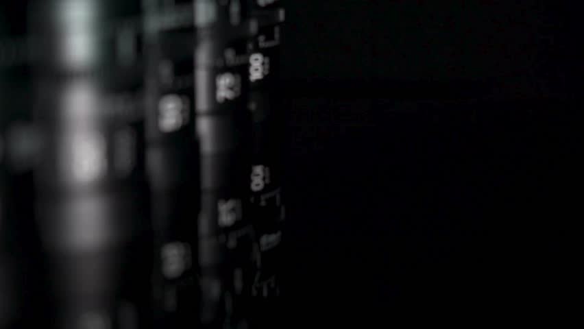 A professional packshot displaying a camera lens in action. This macro, close-up shot captures the precise, intricate movement of the aperture and focusing elements