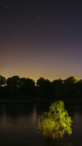 Amazing Starry Effects. 4k Timelapse Night Sky Above River. Star Trails On Night Sky Background. Star Lines Move In Sky. Night Sky Turns Into Morning. From Dusk To Dawn. Dawn Is Coming. Time Lapse