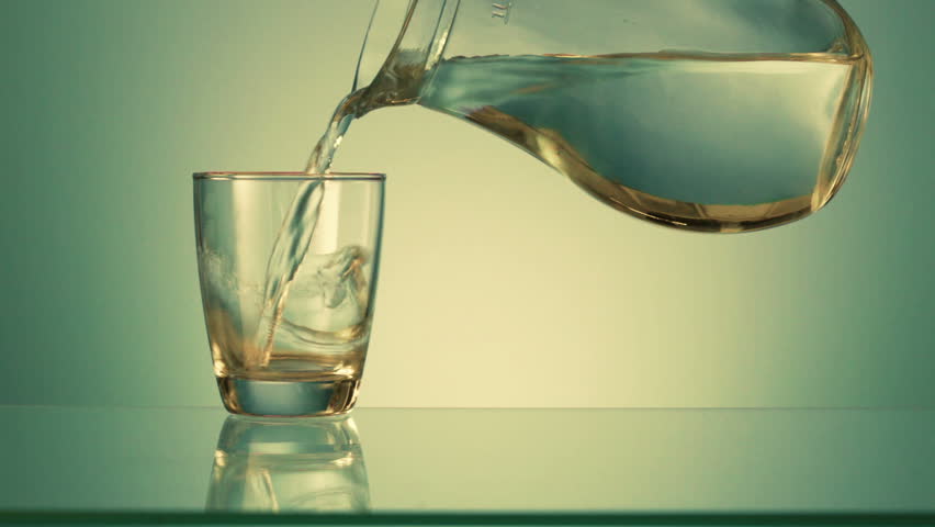 Drinking water is poured into a glass