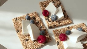 Crispy grain breads with seeds, cheese, ricotta and berries. Breakfast and healthy eating. - Powered by Shutterstock - Get 15% off with code: PIKWIZARD15