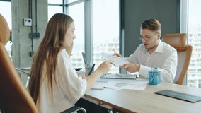 Business meeting between two professionals discussing market analysis in a modern office environment with large windows overlooking the cityscape - Powered by Shutterstock - Get 15% off with code: PIKWIZARD15