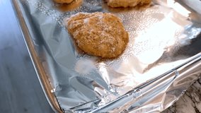 Three unbaked scones covered in coarse sugar sit on a foil-lined baking sheet. The close-up view captures their golden color and raw texture in natural kitchen lighting. - Powered by Shutterstock - Get 15% off with code: PIKWIZARD15