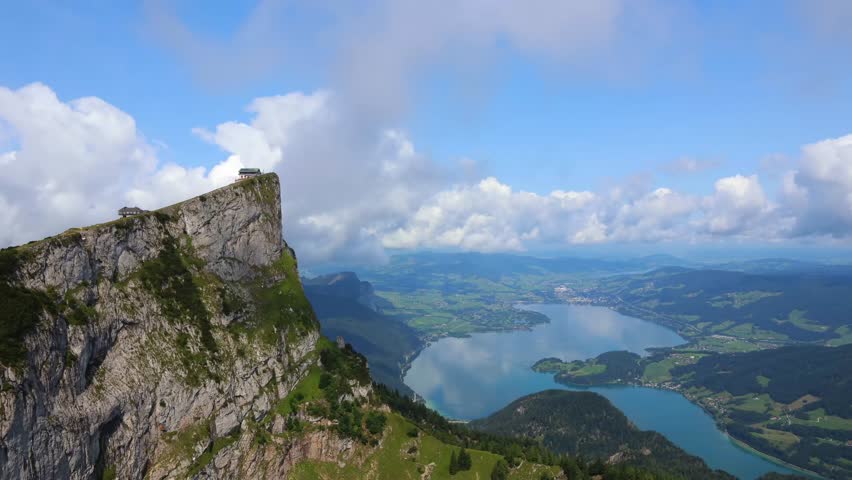 Schafberg mountaintop with Mondsee lake, cloud time lapse. Austria landscape, travel destination background