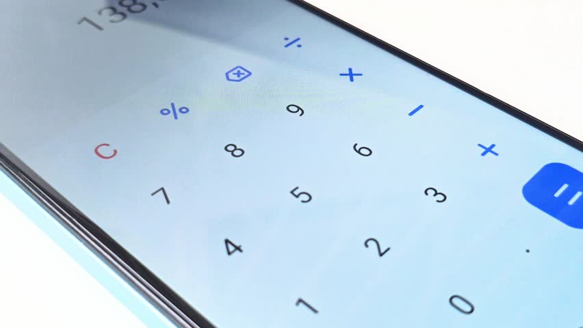 Close-up of a finger using a calculator app on a smartphone. Performing calculations, numbers changing on screen. Modern finance, technology, and digital tools. - Powered by Shutterstock - Get 15% off with code: PIKWIZARD15