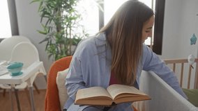 Woman reading book in relaxed bedroom setting with crib and green plants highlighting a cozy interior ambiance of a modern home environment. - Powered by Shutterstock - Get 15% off with code: PIKWIZARD15