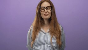 Red haired woman wearing glasses and striped shirt blinks eyes and smiles gently in studio; calm confidence. - Powered by Shutterstock - Get 15% off with code: PIKWIZARD15