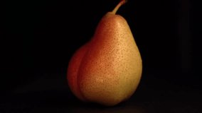Rotating pear on black background with water droplets - Powered by Shutterstock - Get 15% off with code: PIKWIZARD15
