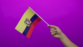 Hand holding ecuadorian flag against vibrant pink background conveying national pride and cultural representation. - Powered by Shutterstock - Get 15% off with code: PIKWIZARD15