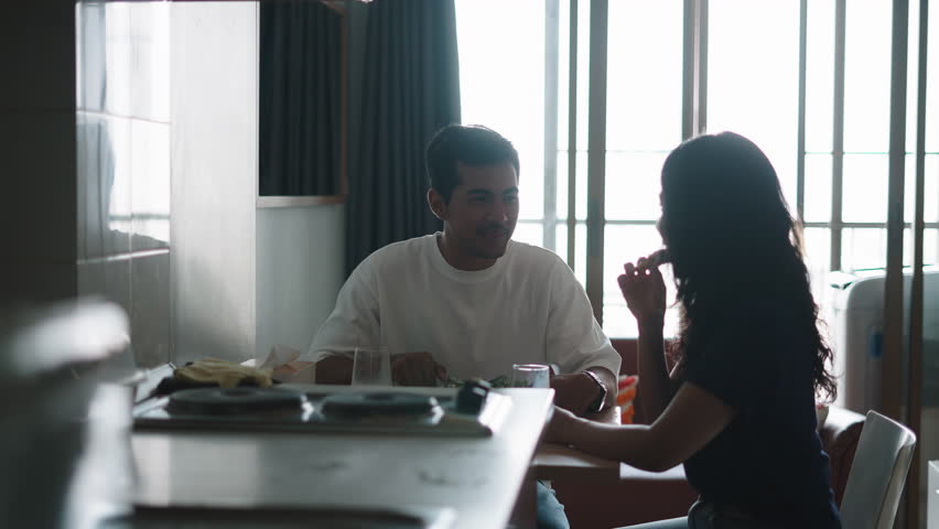 Romantic couple enjoying a meal together at home