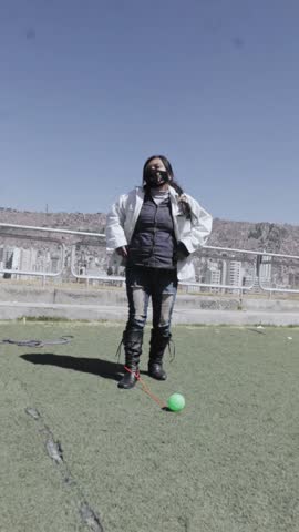 A young woman getting ready before playing with an old toy.