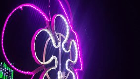 A Vibrant Purple and White LED Light Sculpture of the Sacred Om Symbol Illuminating a Festive Night Event
 - Powered by Shutterstock - Get 15% off with code: PIKWIZARD15