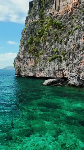 Steep limestone cliff and emerald sea in El Nido, Palawan, Philippines