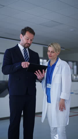 Pharmaceutical sales representative introducing new medication to female doctor.