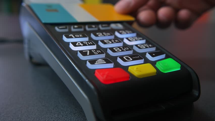 Close up black POS terminal with colored buttons, contactless credit card paymen
