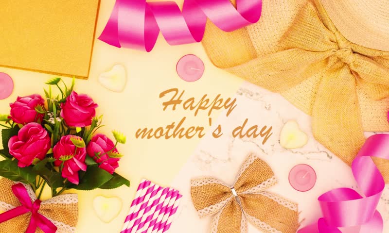 Stop motion  of a “Happy Mother’s Day” title on paper surrounded by feminine accessories like flowers, cosmetics, and gifts. Perfect for Mother’s Day greetings, celebrations, and social media Concept.
