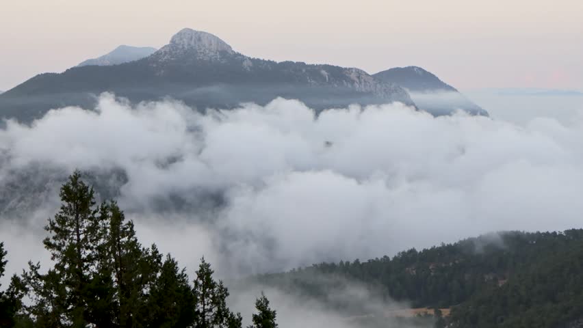 dense cloud cover on mountaintops