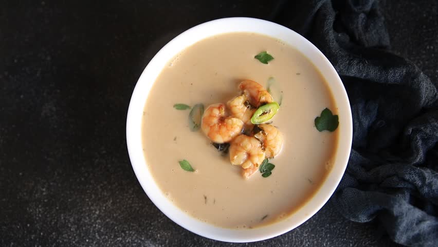 Tom kha soup shrimp, coconut milk, miso paste tasty seafood snack fresh delicious gourmet food background on the table rustic food top view copy space pescetarian diet
