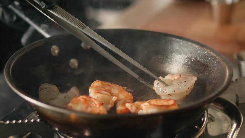 Cooking big shrimps on frying pan. Preparation langoustines Shrimp, Prawn, Langoustine, Scampi, Crayfish, macro cooking on professional kitchen. 