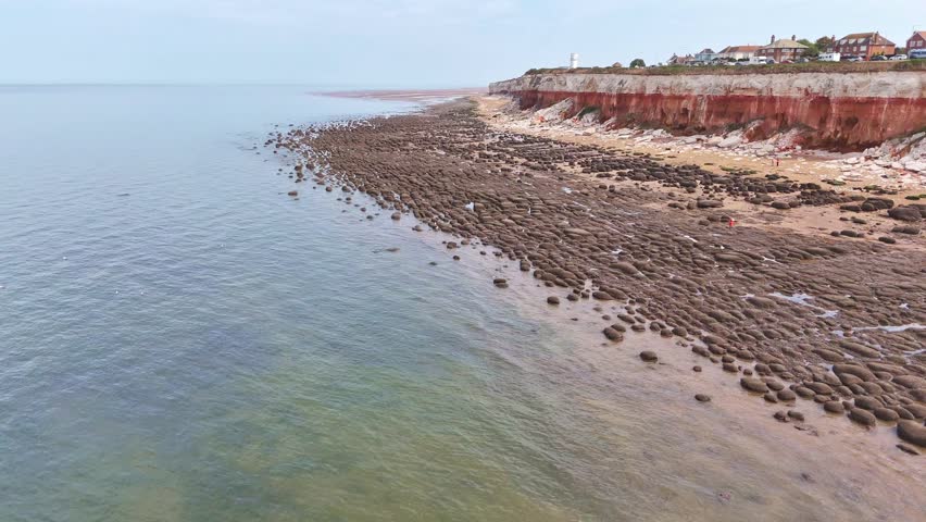 View from the sky over the rock pools towards the stripey cliff face at Hunstanton on the Norfolk coast.